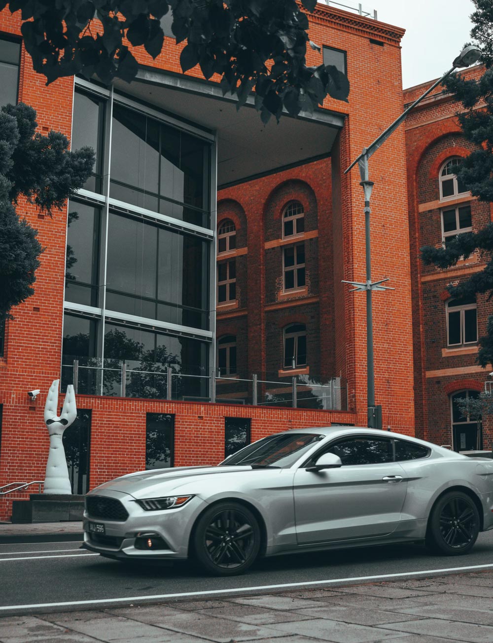 Car parked near red building in Geelong